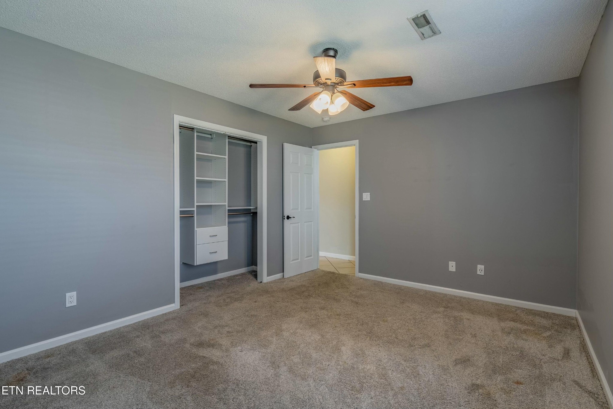 7724 Ralph Youmans Road Corryton, TN 37721 - Photo 10 of 19 a view of an empty room with a ceiling fan