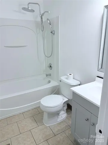 a view of empty room with wooden floor and window