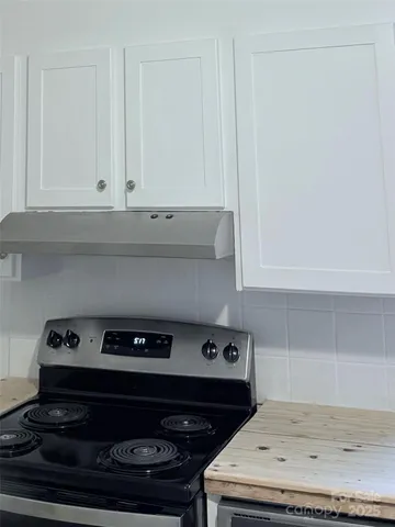 a kitchen with a stove and cabinets