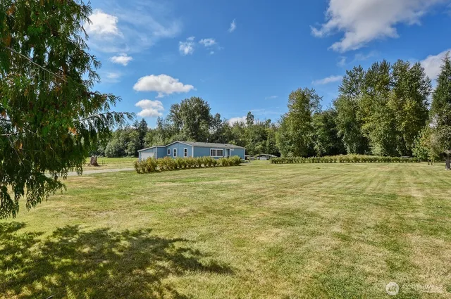 a blue swimming pool is in the middle of a garden