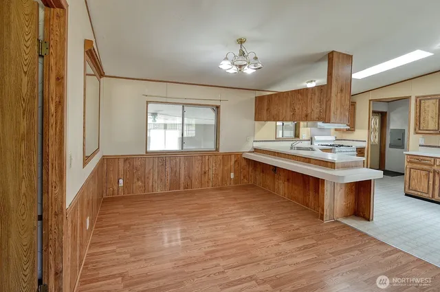 a large kitchen with kitchen island a sink stainless steel appliances and cabinets