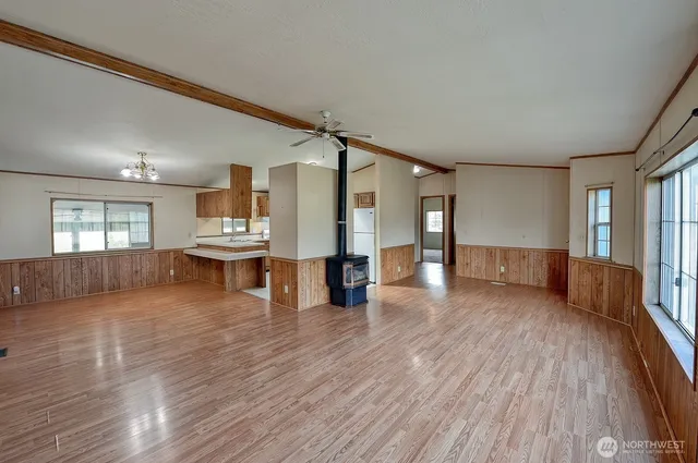a view of a living room with wooden floor and a window