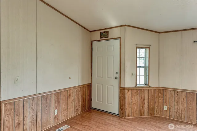 a view of an entryway with wooden floor