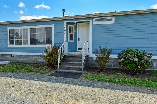 a front view of a house with a garden