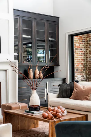 a living room with furniture and floor to ceiling windows