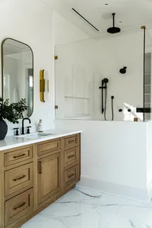 a bathroom with a double vanity sink and mirror