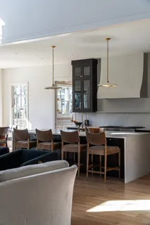 a living room with furniture a window and kitchen view