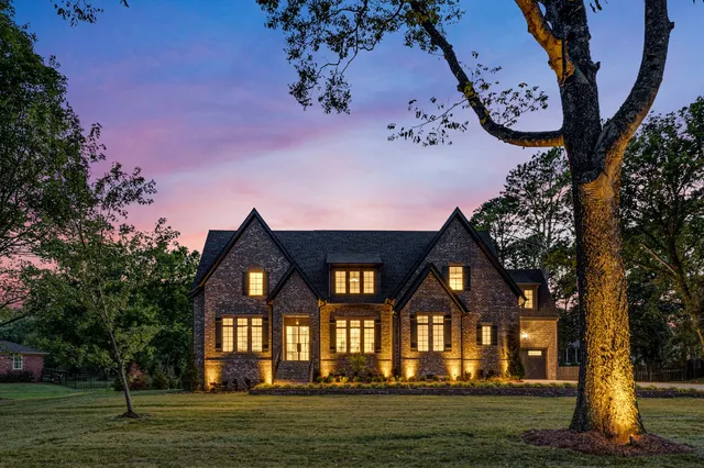 a front view of a house with a garden