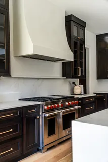 a kitchen with stainless steel appliances a stove and a microwave