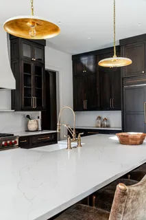 a kitchen with a counter space a sink and cabinets