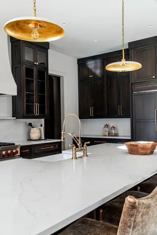 a kitchen with a counter space a sink and cabinets