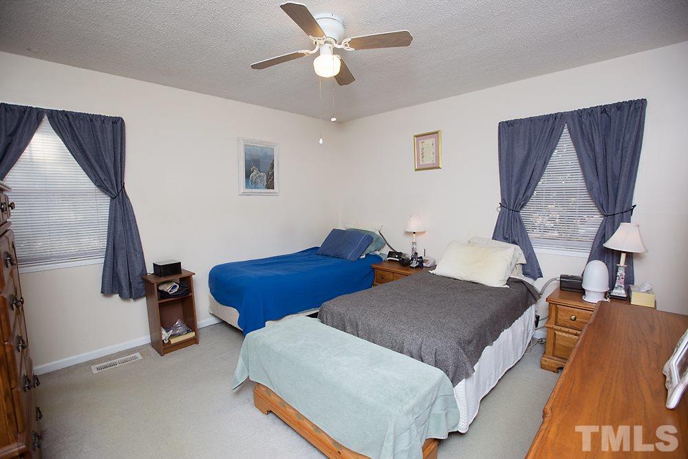 5602 McCormick Road Durham, NC 27713 - Photo 11 of 19 a bedroom with a bed and wooden floor