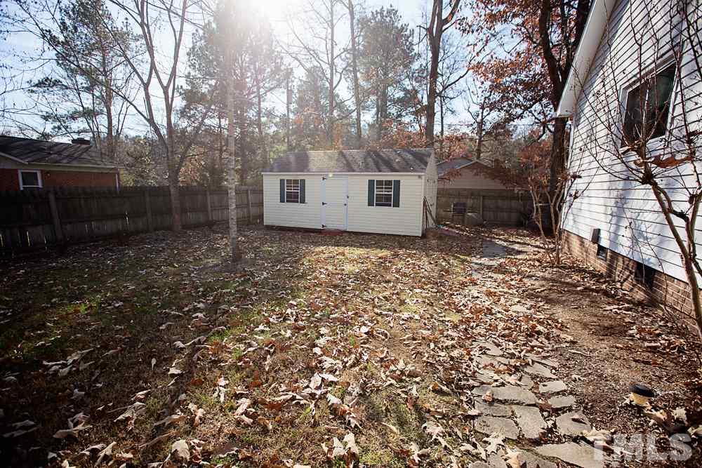 5602 McCormick Road Durham, NC 27713 - Photo 17 of 19 a backyard of a house with lots of green space