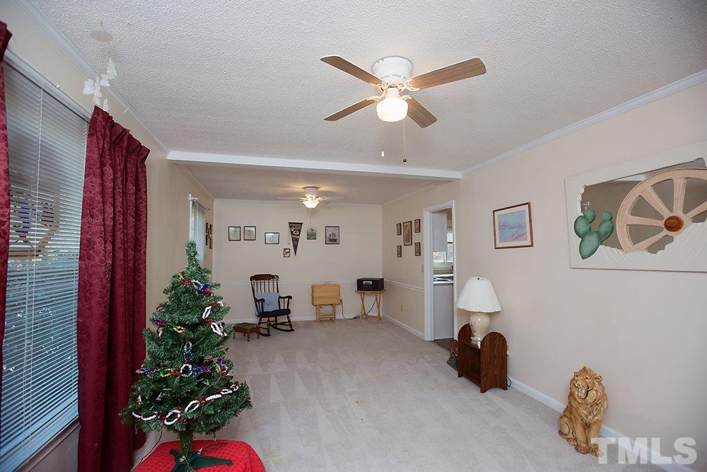 5602 McCormick Road Durham, NC 27713 - Photo 3 of 19 a living room with furniture and a chandelier
