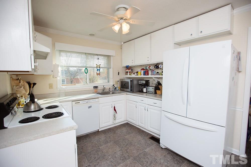 5602 McCormick Road Durham, NC 27713 - Photo 4 of 19 a kitchen with appliances a sink and cabinets