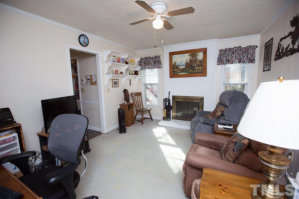 5602 McCormick Road Durham, NC 27713 - Photo 7 of 19 a living room with furniture and a fireplace