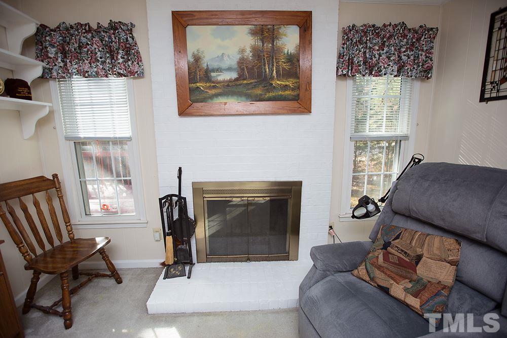 5602 McCormick Road Durham, NC 27713 - Photo 8 of 19 a living room with furniture a window and a fireplace