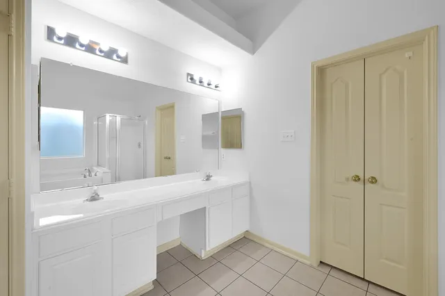 a white bath tub sitting next to a shower