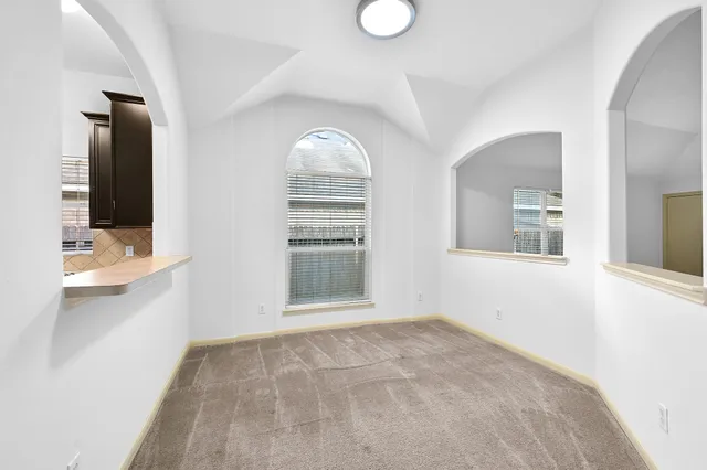 a view of empty room with a fireplace