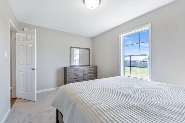 a bedroom with a bed and a mirror