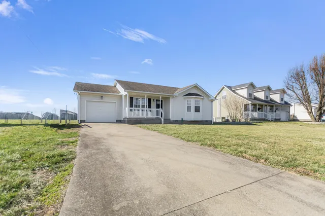 a view of a house with backyard and trees
