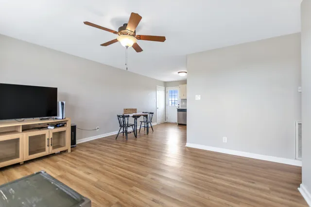 a view of a livingroom with furniture and a flat screen tv