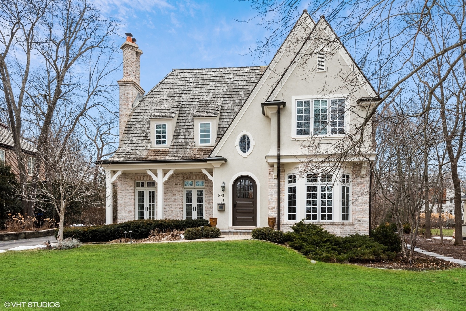a view of a white house with yard and plants