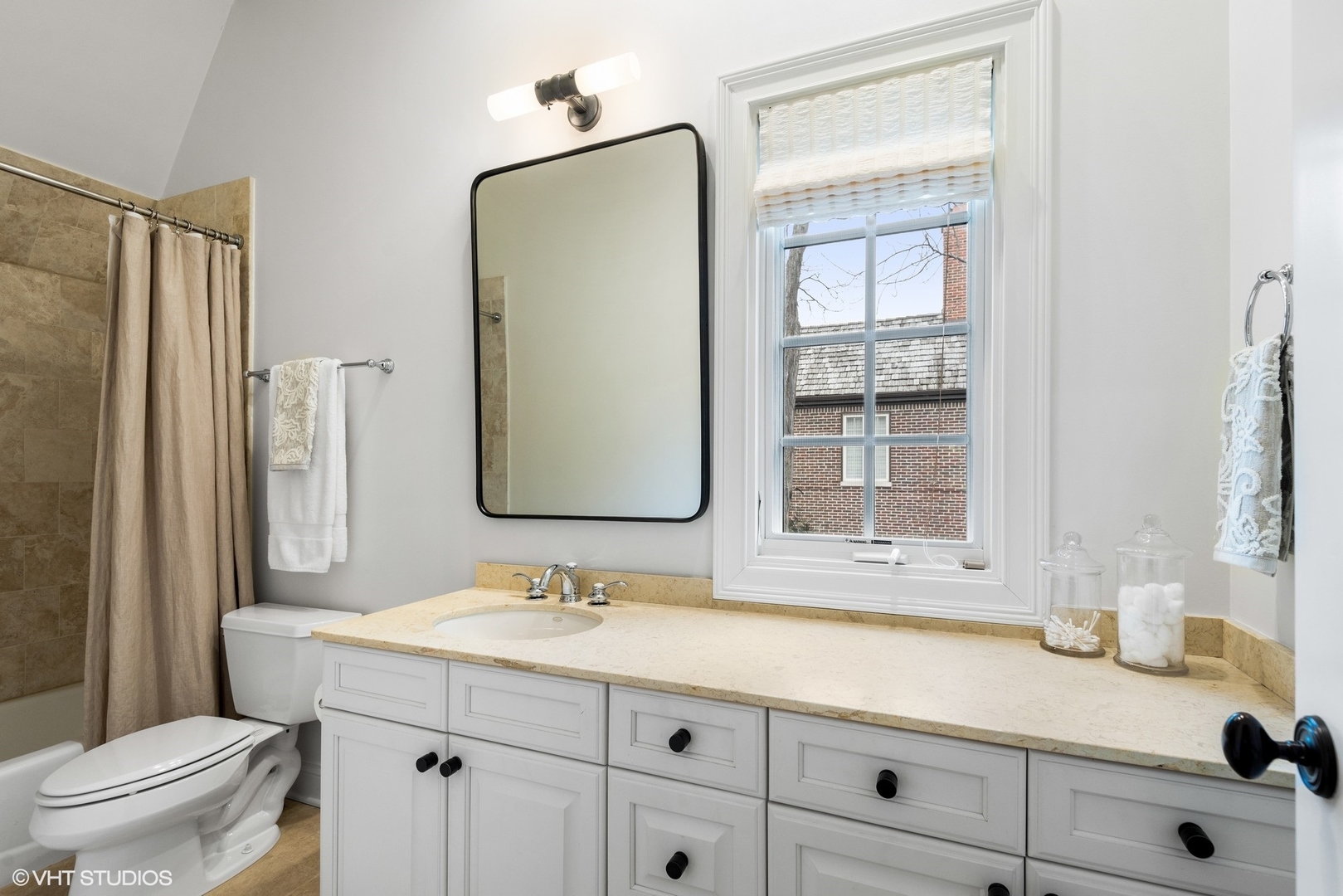 861 Bluff Street Glencoe, IL 60022 - Photo 29 of 51 a bathroom with a sink a toilet and a large mirror