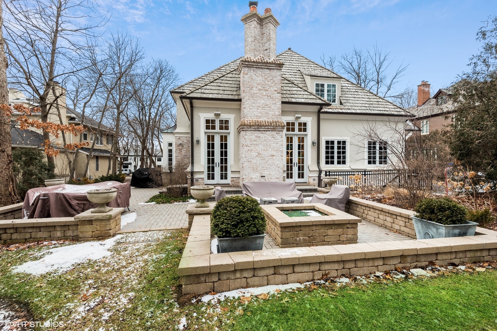 861 Bluff Street Glencoe, IL 60022 - Photo 44 of 51 a view of a white house with large windows and couches chairs