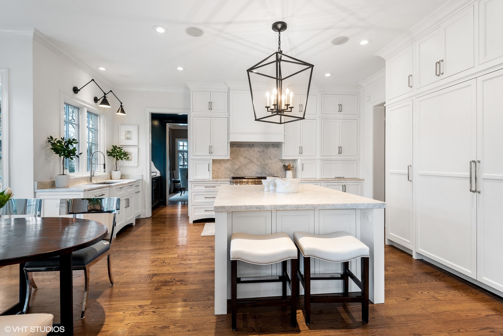 861 Bluff Street Glencoe, IL 60022 - Photo 7 of 51 a large kitchen with kitchen island a table and chairs in it