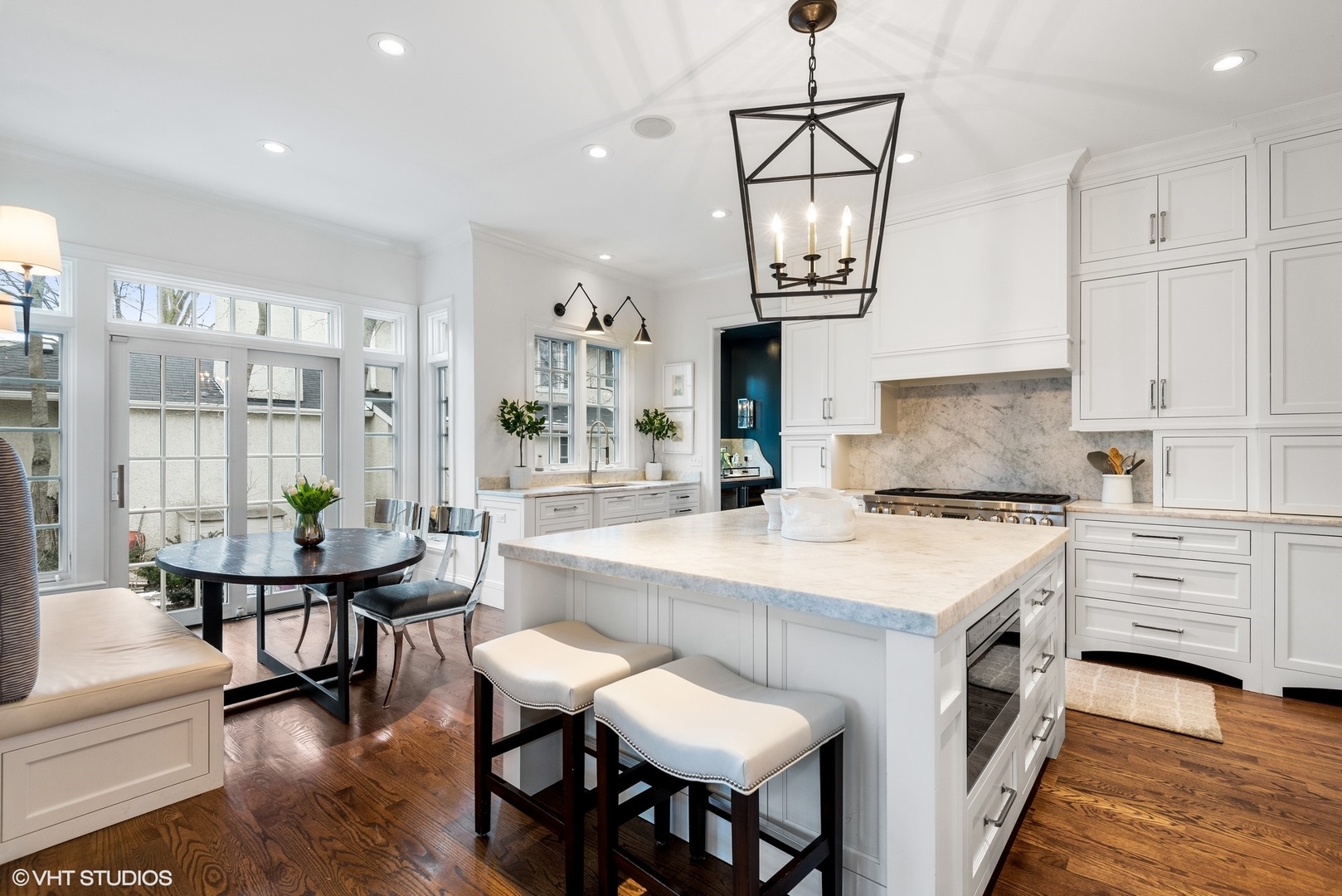 861 Bluff Street Glencoe, IL 60022 - Photo 10 of 51 a kitchen with a dining table chairs and white cabinets