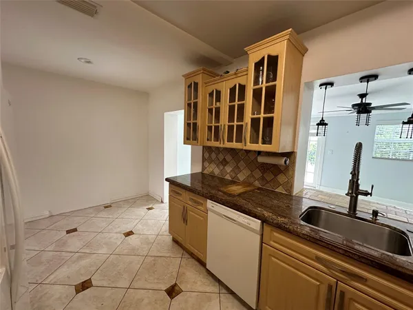 a kitchen with stainless steel appliances granite countertop a sink and cabinets