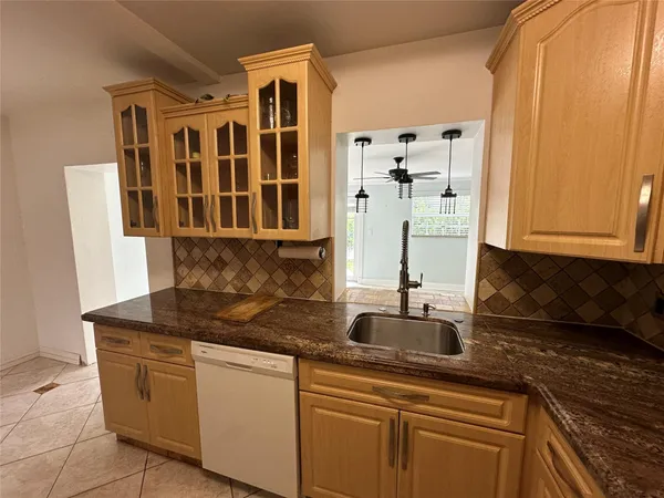 a kitchen with stainless steel appliances granite countertop a sink and cabinets