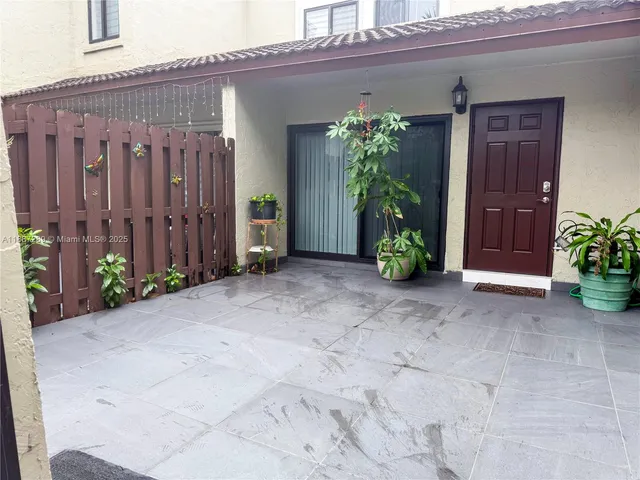 a view of potted plant in front of a door
