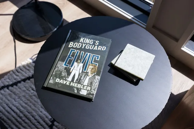 a living room with furniture kitchen view and a window