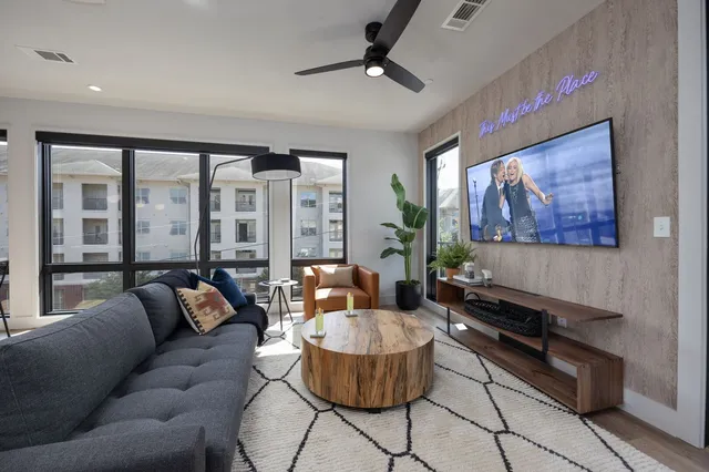 a living room with furniture and a large window