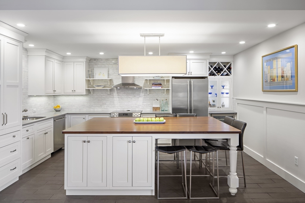 9 Appleton Street, Unit 304 Boston, MA 02116 - Photo 1 of 18 a kitchen with stainless steel appliances granite countertop a stove top oven a sink dishwasher and a refrigerator with wooden floor