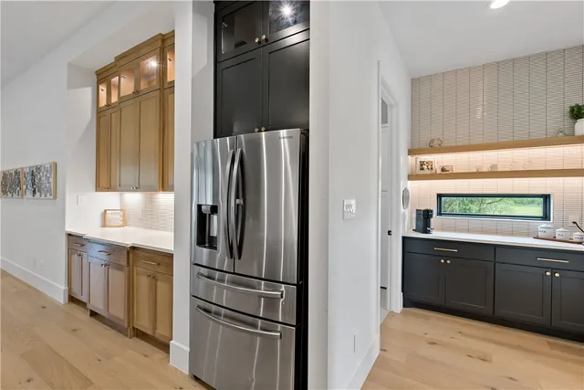 a kitchen with stainless steel appliances granite countertop a sink a stove and a refrigerator