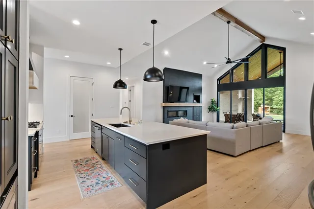 a kitchen with stainless steel appliances kitchen island granite countertop a stove a sink and a microwave