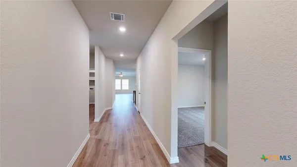 a kitchen with stainless steel appliances a refrigerator and a stove top oven