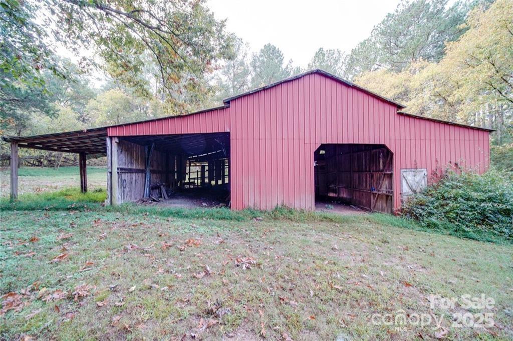 1608 East Main Street Locust, NC 28097 - Photo 5 of 10 a view of a house with a yard and large tree