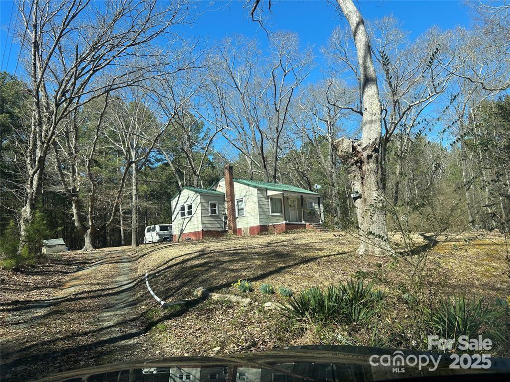 1608 East Main Street Locust, NC 28097 - Photo 9 of 10 a view of a white house with a yard with wooden fence