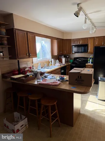 a kitchen with a sink cabinets and window