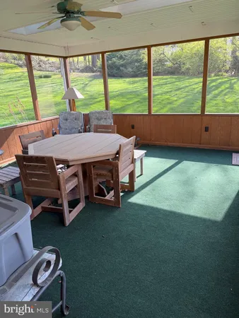 a room with pool table and windows