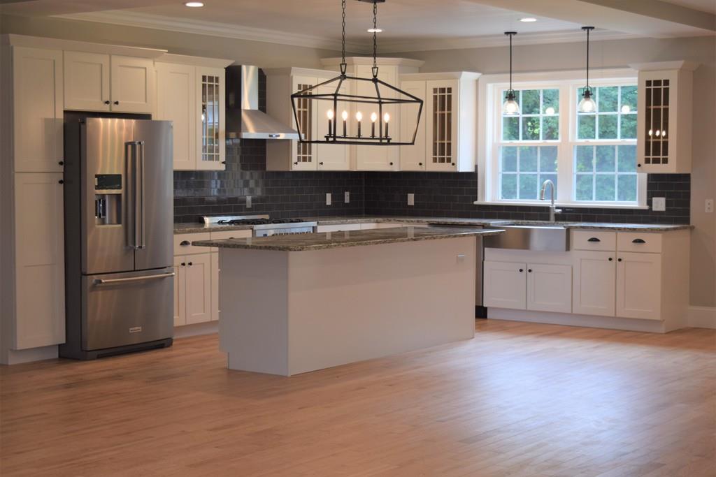 298 New Bedford Road Rochester, MA 02770 - Photo 11 of 31 a kitchen with stainless steel appliances granite countertop a refrigerator a sink a stove and a wooden floors