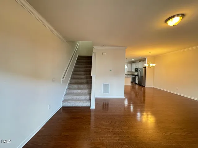 a view of entryway and hall with wooden floor