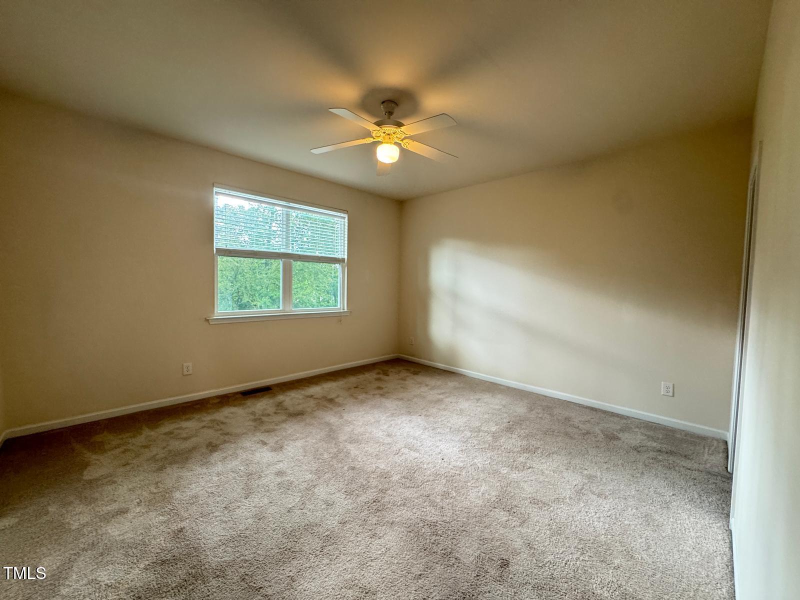 1026 Diamond Dove Lane Apex, NC 27502 - Photo 14 of 22 an empty room with a window and a fan