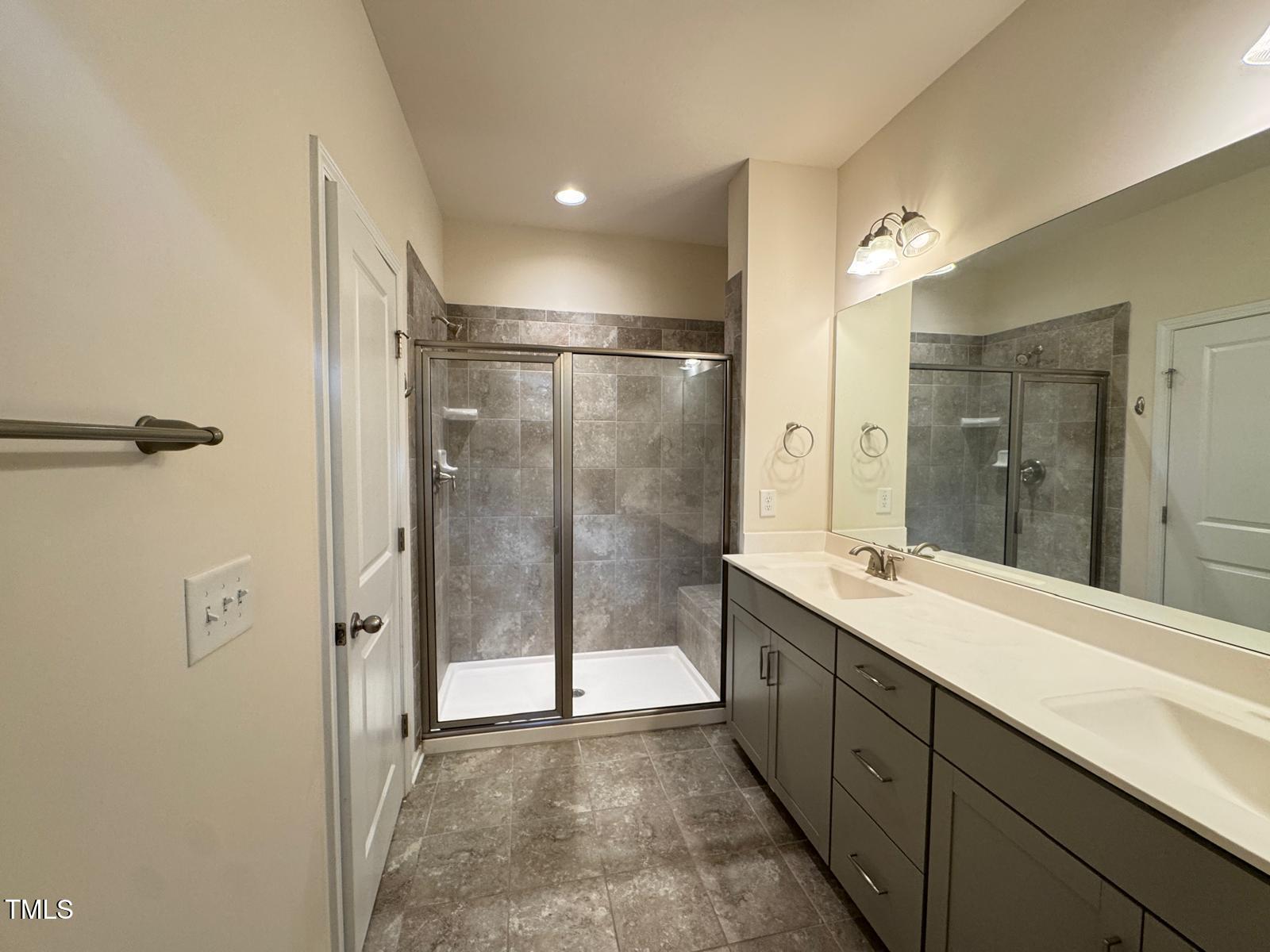 1026 Diamond Dove Lane Apex, NC 27502 - Photo 16 of 22 a spacious bathroom with a shower sink and mirror