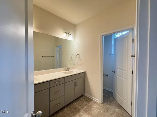 a spacious bathroom with a double vanity sink and mirror