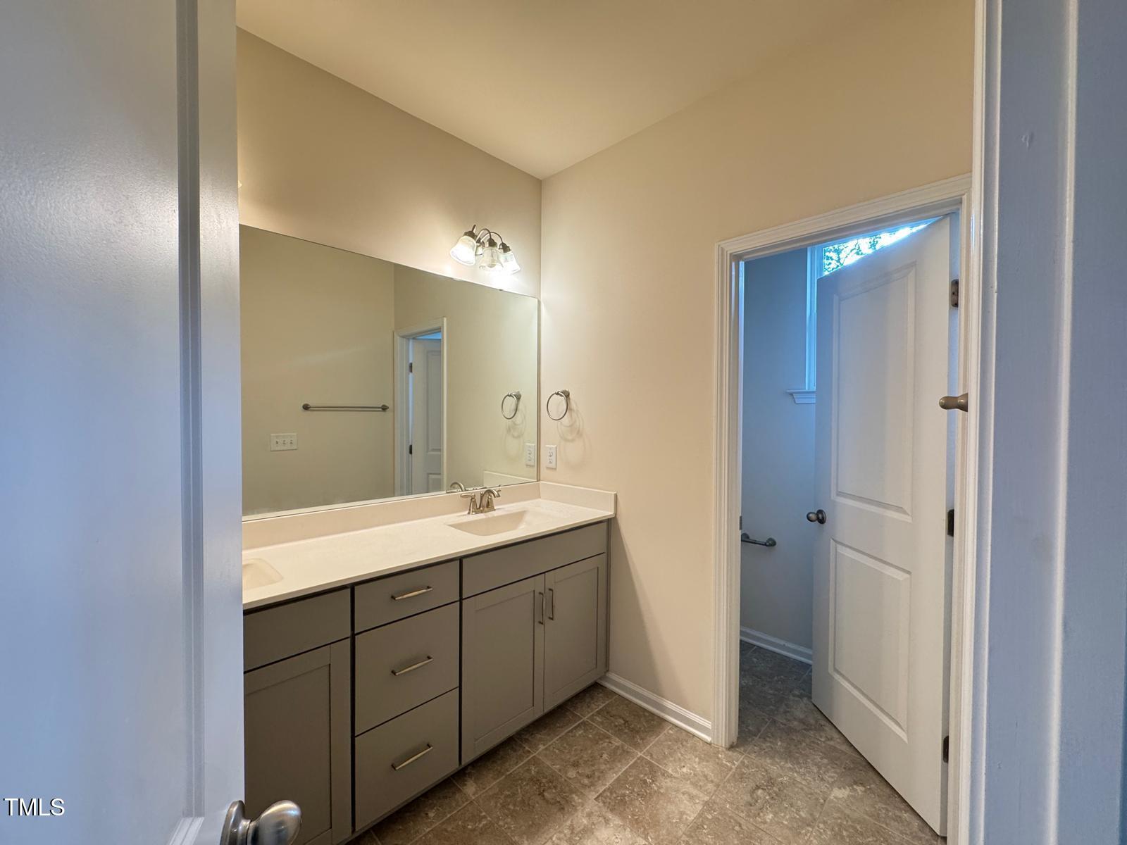 1026 Diamond Dove Lane Apex, NC 27502 - Photo 18 of 22 a spacious bathroom with a double vanity sink and mirror